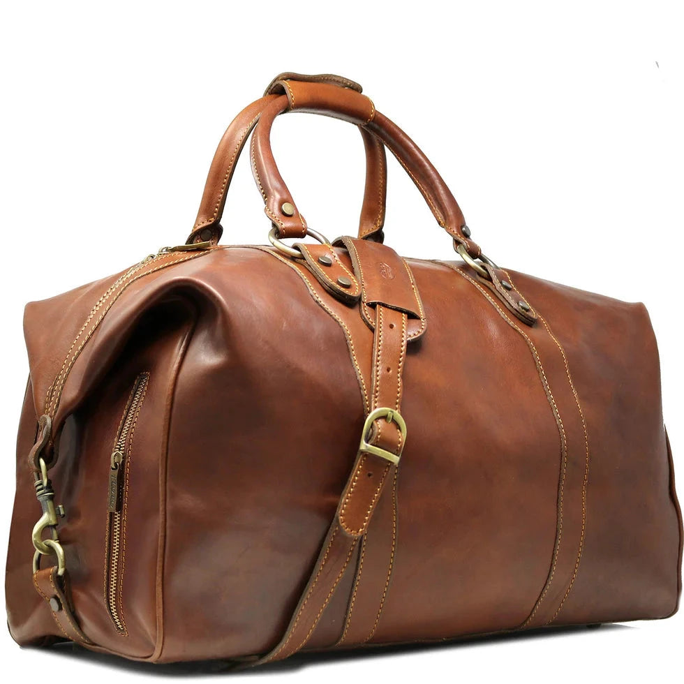 A brown leather duffel bag with handles and a shoulder strap.