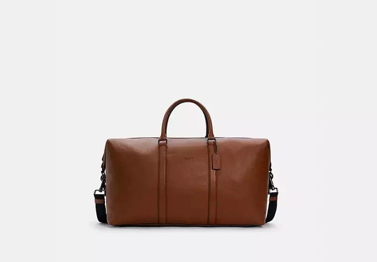 Brown leather duffel bag with handles and detachable shoulder strap.