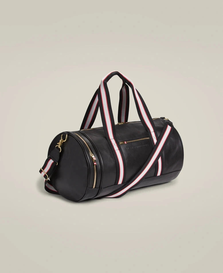 Sleek black leather duffle bag with handles and detachable shoulder strap.