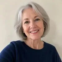 Linda, 64, the author, smiling at home