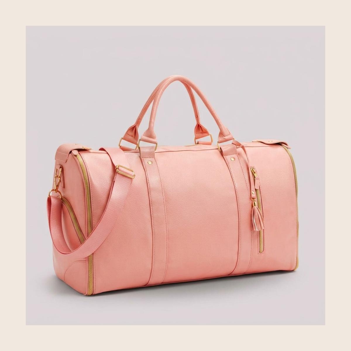 The rose pink Vohxe Travel Bag 2.0 standing upright, soft leather with gold zippers and detachable strap