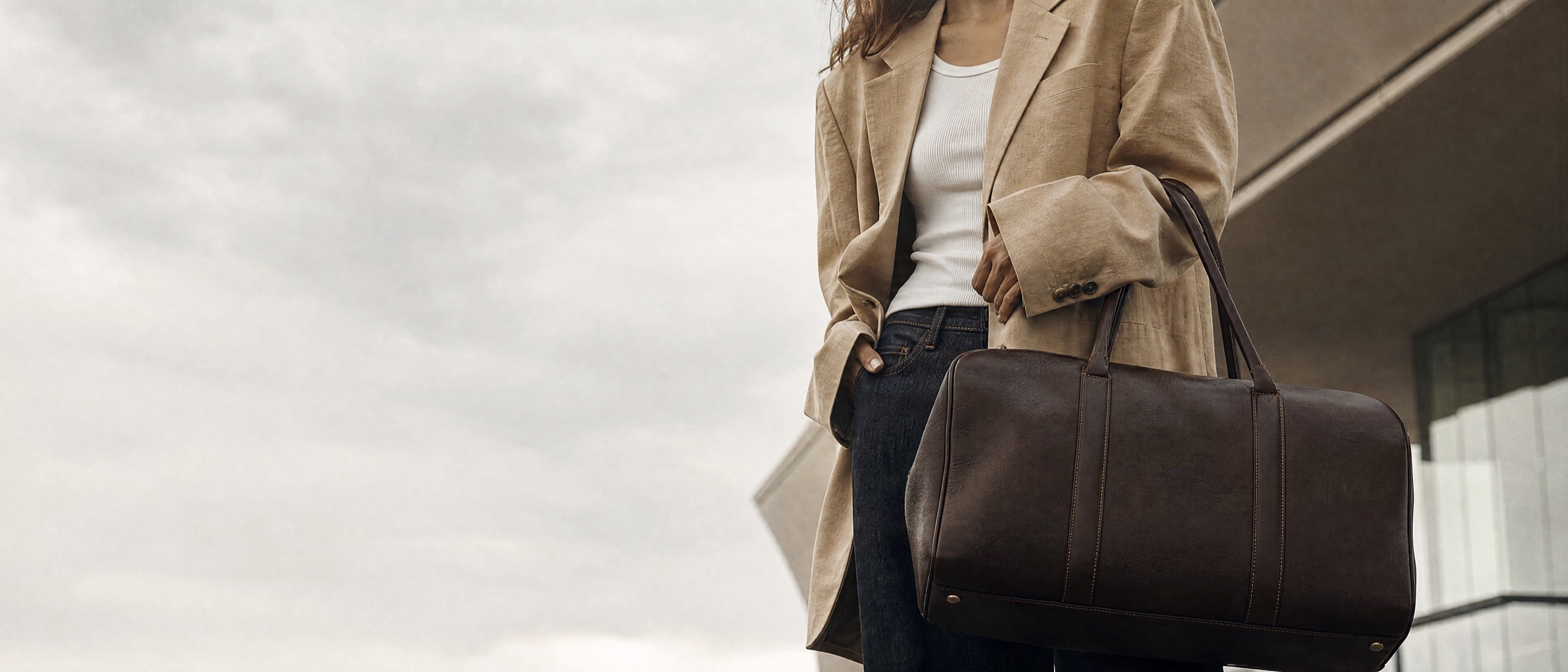 Vohxe leather weekender duffel carried through the terminal