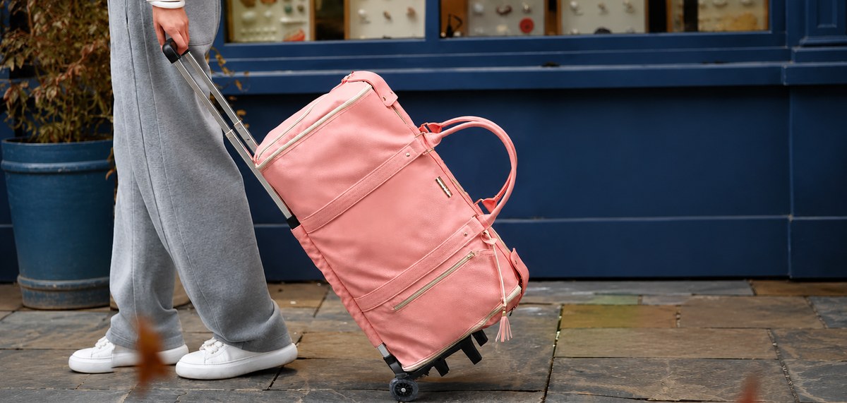 Rolling the Vohxe Travel Bag 2.0 down a city street
